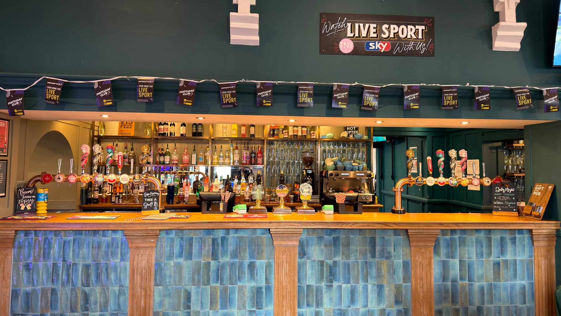 Beer being poured at the bar inside The Old School House pub.